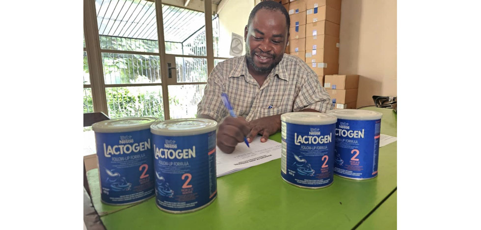 Mr Moses Semwayo collects milk formula for his eight-months-old nephew