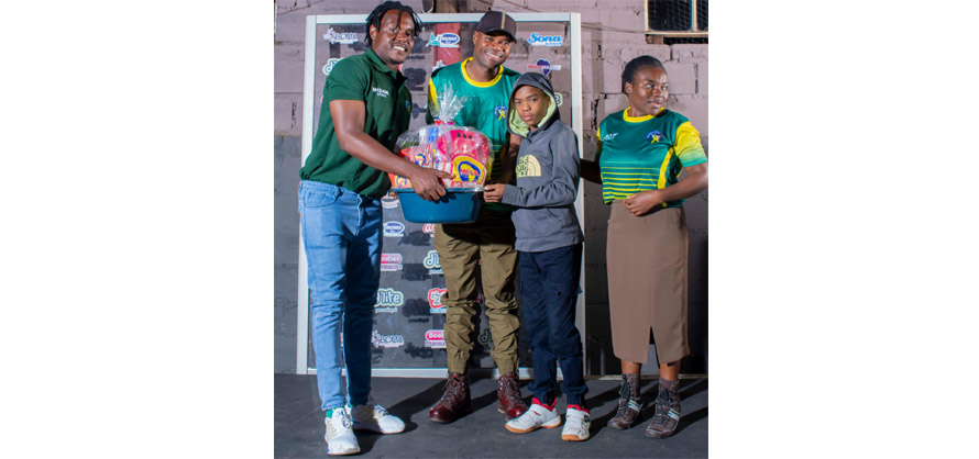 The Corel Liquids Private Ltd Player of the Year – Under 19 Woman award winner Passionate Munorweyi receives her award collected by her family from Victor Nyauchi (in green)