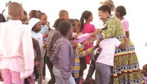 First Lady Dr Auxillia Mnangagwa is swarmed by children who wanted to hug her during one of her numerous interactions with children around the country