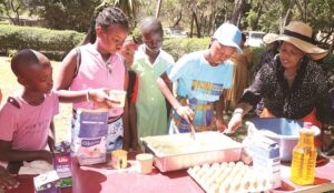 First Lady Dr Auxillia Mnangagwa teaches girls how to bake during one of her numerous girls’ camps