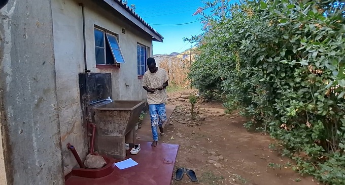 Nelson Mwanza at the house where he lives alone following the death of his parents