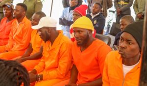 Marondera Female Open Prison male inmates follow proceedings during the official opening of the digital and vocational training centre by First Lady Dr Auxillia Mnangagwa