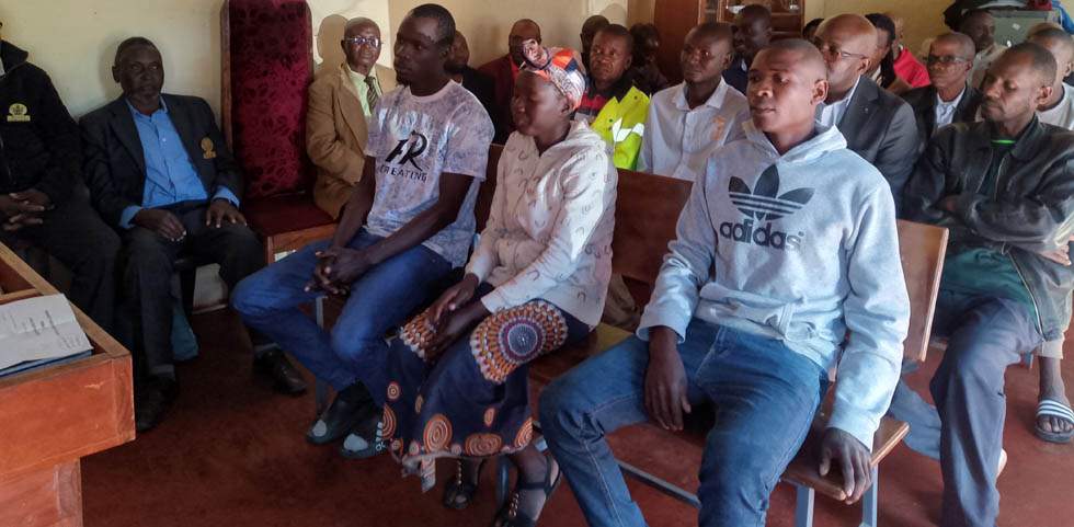 (From left) Learmore Guri, his wife, Theresa and Peter Mwanza in court