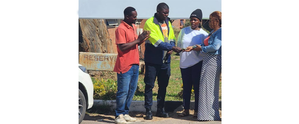 HELPING HAND . . . Pacific Eastern Region outfit Buffaloes FC chairman and Socco Golden Stars social football side owner Ruramai Nyakonga (in worksuit) handing over US$500 to the mother of injured Mutare United Juniors player Petros Simbarashe Machara (far right) while the young players' coach Gabriel Mhundu (left) and Simbarashe's sister Barbra look on