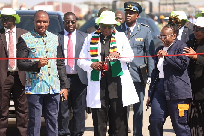 President Mnangagwa cuts the ribbon to officially commission the US$88 million state-of-the-art Trabablas Interchange in Harare on Friday, assisted by Transport and Infrastructural Development Minister Felix Mhona (left) and Permanent Secretary in the ministry, Engineer Joy Makumbe. — Picture: Believe Nyakudjara