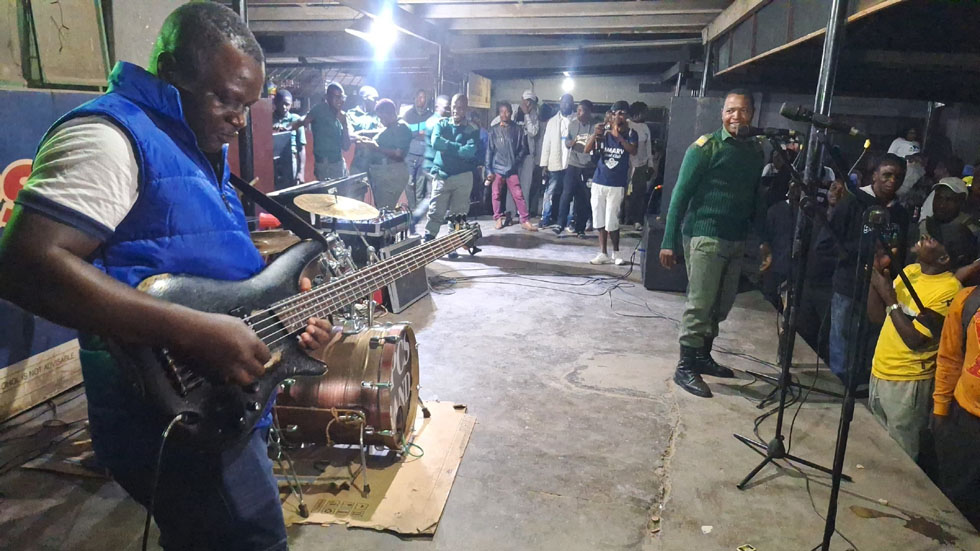 Tau Mwanyisa strums his stuff on the bass guitar