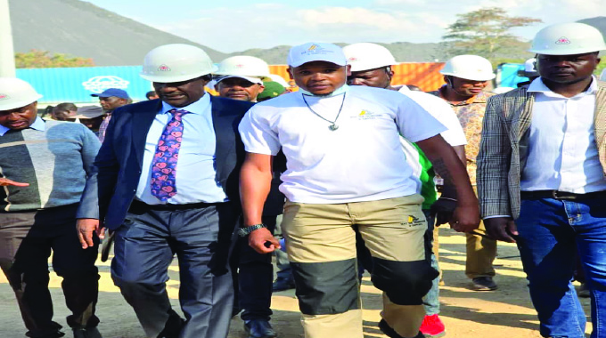 Minister Owen Ncube (left) tours Global Union Alloy chrome processing plant in Kwekwe