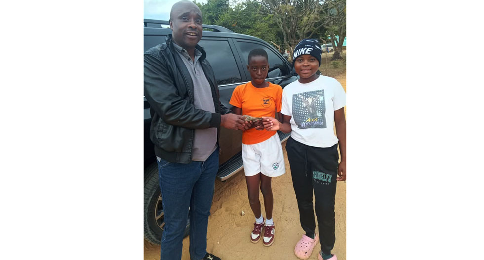 HELPING HAND . . . Mutasa ZANU PF District Coordinating Committee chairman, Washington Ziwiwi (left) hands over cash donation from Members of the House of Assembly from Mutasa District - Misheck Mugadza, Obey Bvute and Innocent Benza to the district’s NAPH teams
