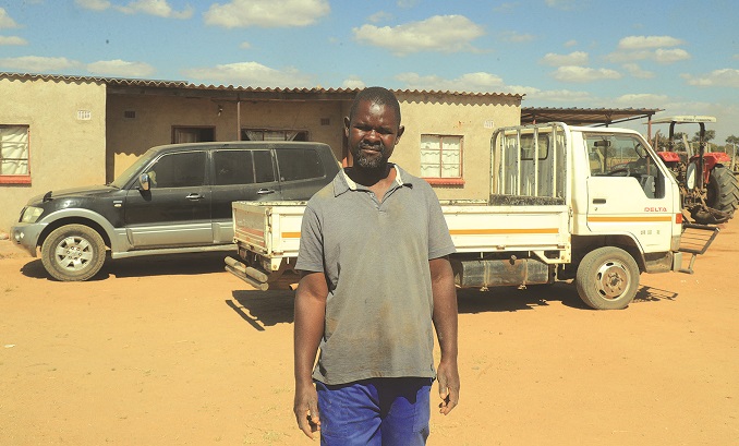 The farmer shows off some of the proceeds from tobacco farming. — Pictures: Kudakwashe Hunda