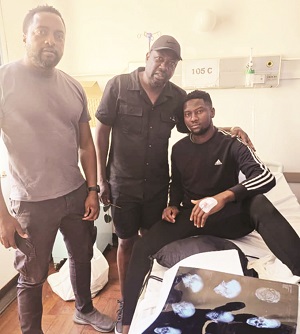 GROUNDED . . . CAPS United president Farai Jere (centre) and club doctor Modercai Sachikonye (left) chat with Brighton Manhire after visiting him at a local medical facility on Monday — pic CAPS United media