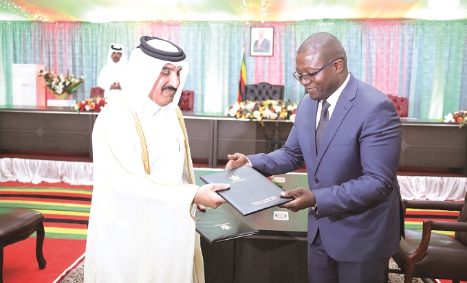 Industry and Commerce Minister Mangaliso Ndlovu exchanges documents with Al Mansour Holdings owner Sheikh Mansour Bin Jabor Bin Jassim Al Thani after signing a Memorandum of Understanding at State House