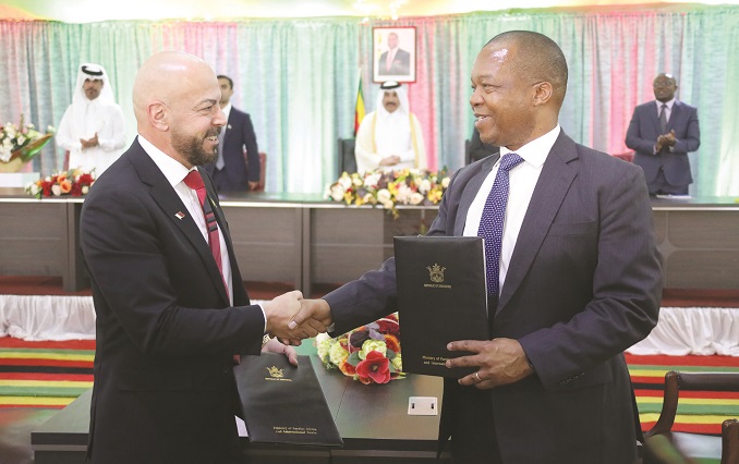 Mutapa Investment Fund chief executive Dr John Mangudya and Al Mansour Holdings chairman Nidal Ammache exchange documents after signing a Memorandum of Understanding at State House