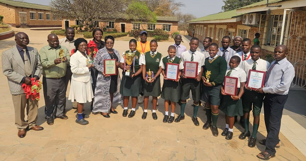 Staff members and learners proudly display the accolades they won at the Merit Award ceremony