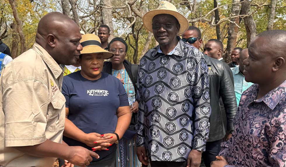 Vice President Cde Kembo Mohadi listens as Mr Lovermore Mandima, the Regional Director for National Museums and Monuments Mandima (far left) explains the history and current state of Doreoi Shrine on site while Deputy Minister of Home Affairs and Cultural Heritage Cde Chido Sanyatwe and Zimbabwe Consular to Beira Mr Malvin also pay attention