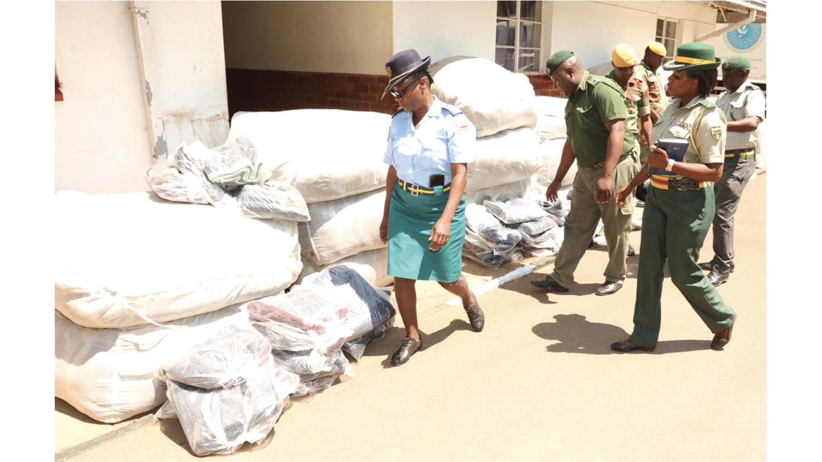 Medical personnel from the Zimbabwe Republic Police, Zimbabwe Prisons and Correctional Services, and the Zimbabwe National Army sort the blankets for their respective hospitals, which they received from First Lady Dr Auxillia Mnangagwa at Zimbabwe House yesterday