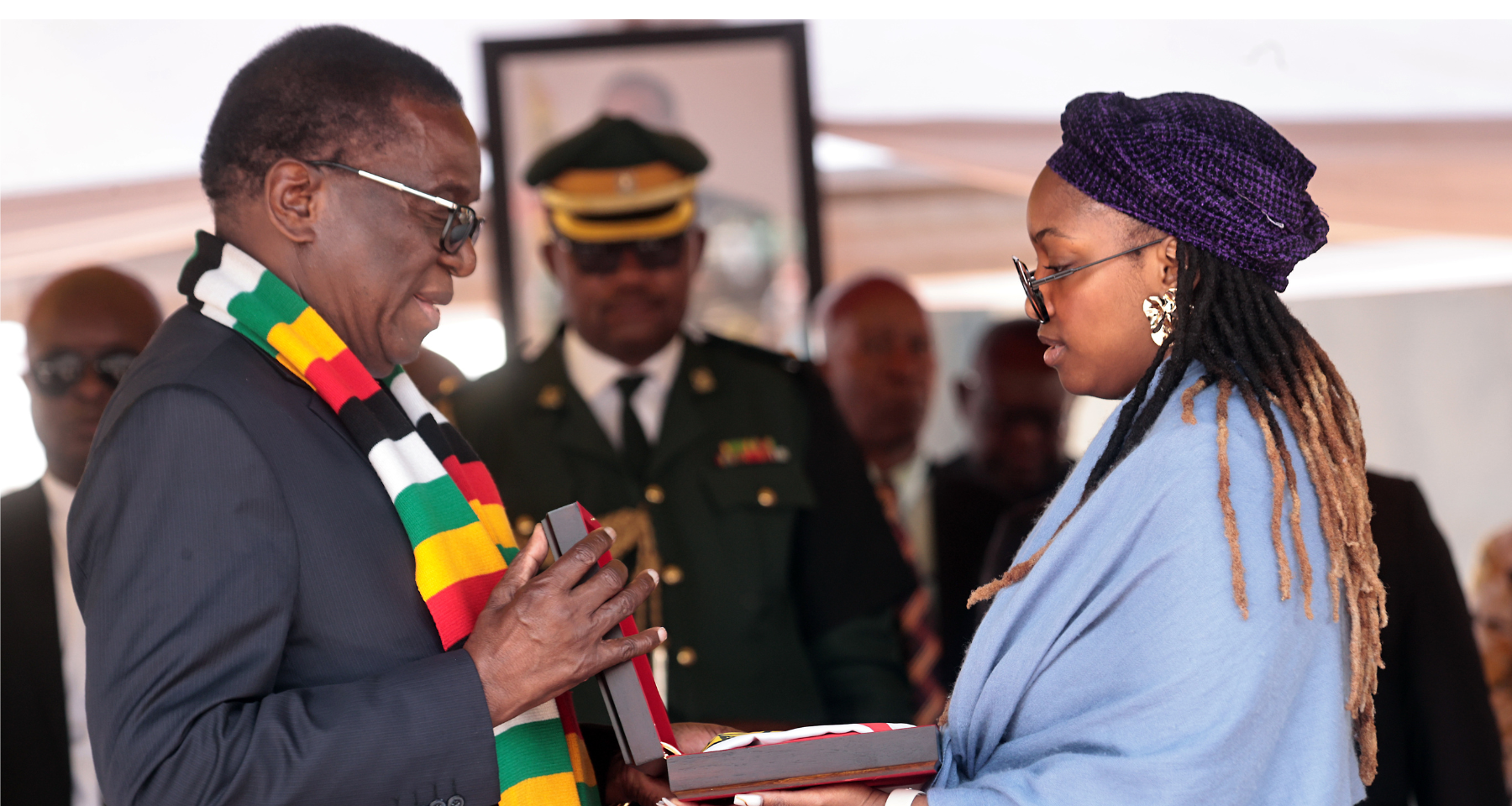 President Mnangagwa hands the National Flag to the widow of late national hero Brigadier-General (Rtd) Mpandasekwa Mzheri at the National Heroes Acre in Harare yesterday