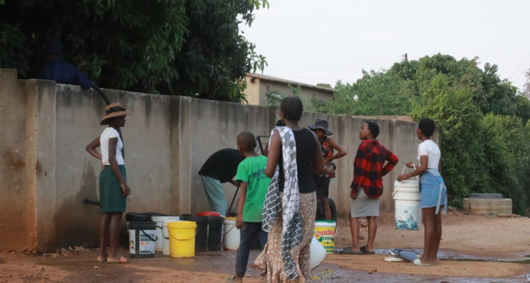 Residents buying water at a Nkulumane house