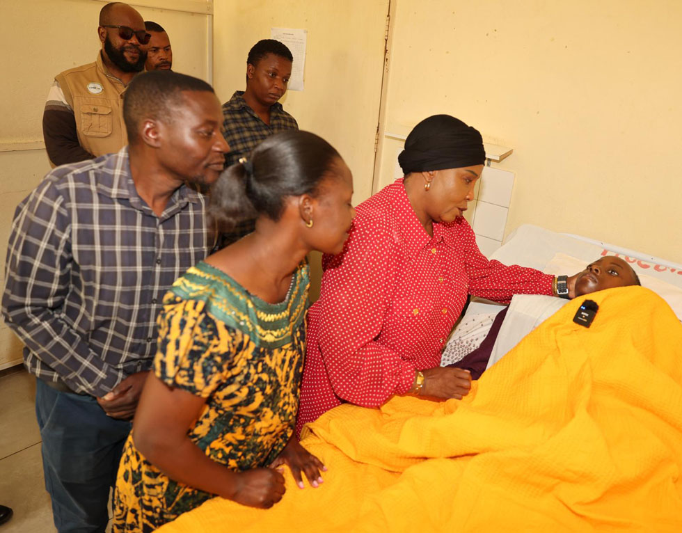 Dr Mnangagwa interacts with Adrain, while his parents look on