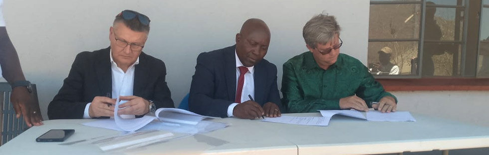 Alrosa managing director Mr Sergey Loshkarev (left), Chimanimani West legislator Honourable Wilson Maphosa and Chimanimani East legislator Honourable Joshua Sacco sign documents during the handover and takeover ceremony of the infrastructure and income generating projects