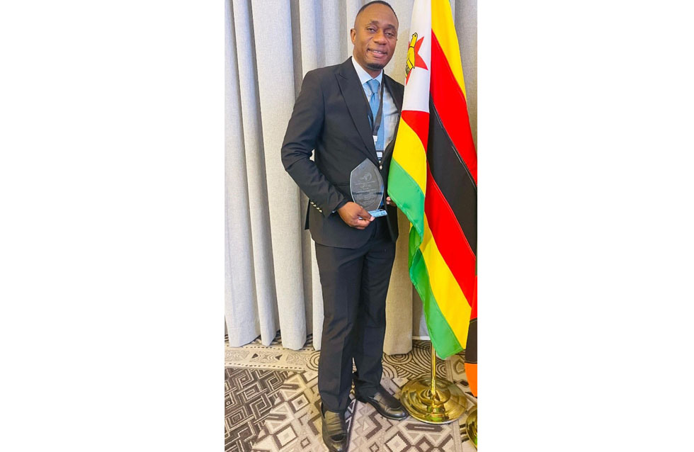 Lloyd Makonya poses for a photo after receiving the award