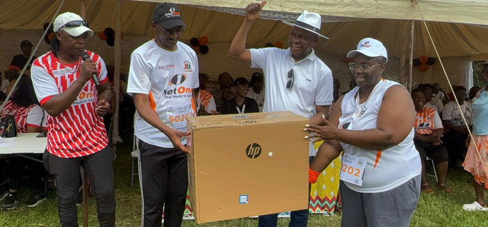 FOR A WORTHY CAUSE . . . Senator Chief Mutasa (second from right) is all smiles after receiving the computers donation from NetOne chief executive offiver Engineer Raphael Mushanawani (second from left)