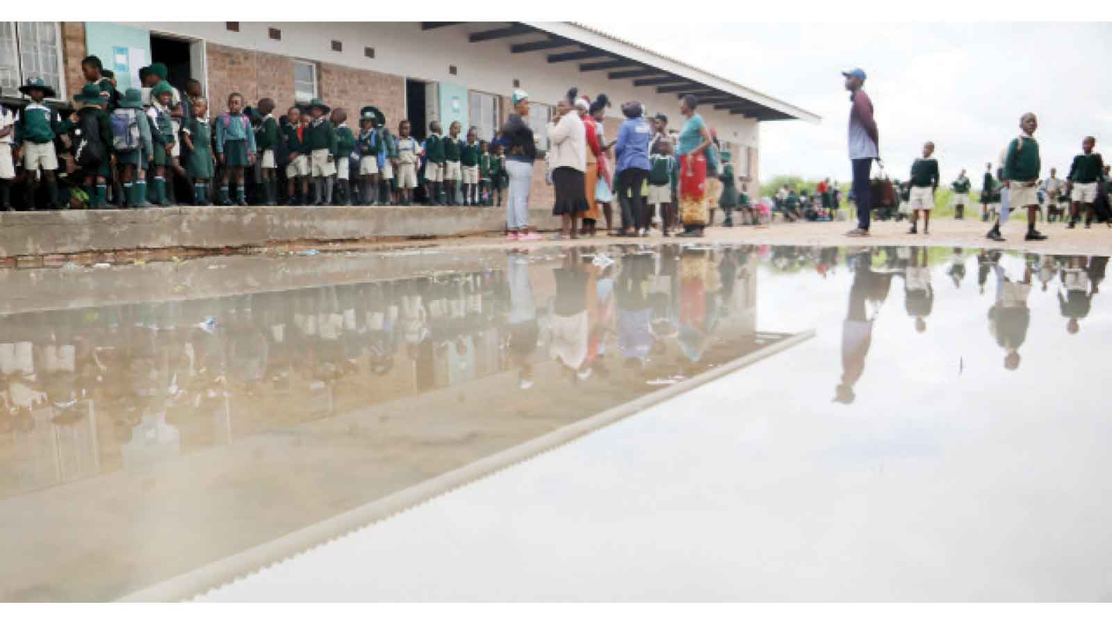 TRAPPED BY THE FLOOD . . . Rains flood homes, disrupt schools and raise health fears
