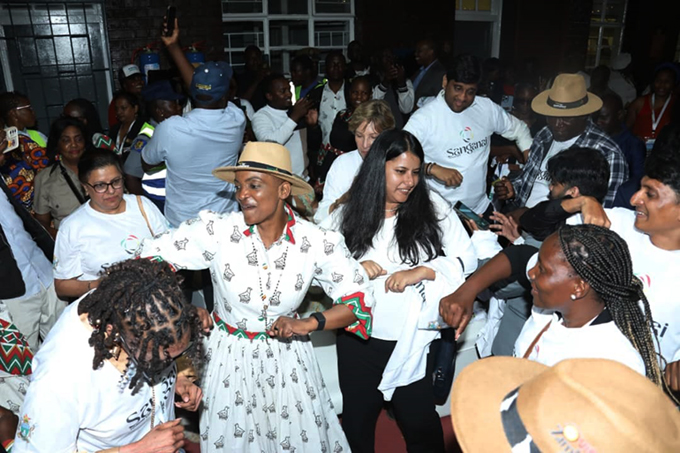 Tourism and Hospitality Industry Minister, Honourable Barbra Rwodzi with tourists, celebrate the arrival of a luxury train to Mutare