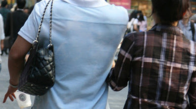 Love or Simp? Men slinging handbags divide the streets