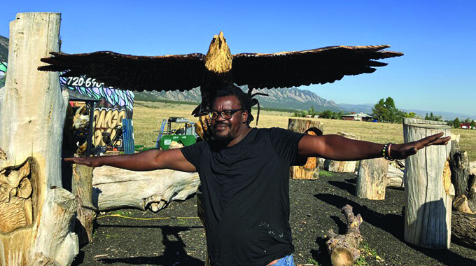 The master of the chainsaw: Bongo Love, master carver bringing the art back home