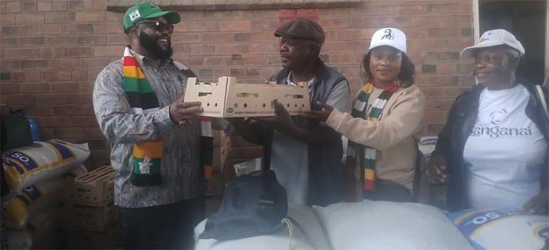 Minister of State for Manicaland Provincial Affairs and Devolution, Advocate Misheck Mugadza (left) hands-over the chicks to beneficiaries