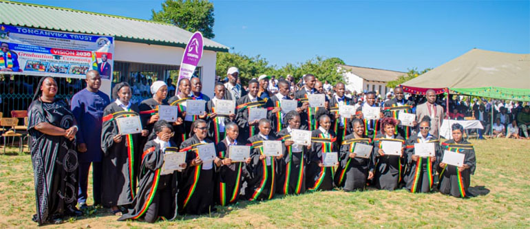 Graduands pose with their certificates