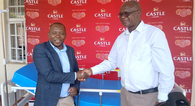 Victoria Chitepo Provincial Hospital medical superitendant, Dr Hillary Makiwa (left) receives the donations from Delta Beverages Regional Sales Manager, Mr Julius Chirara this morning at the hospital