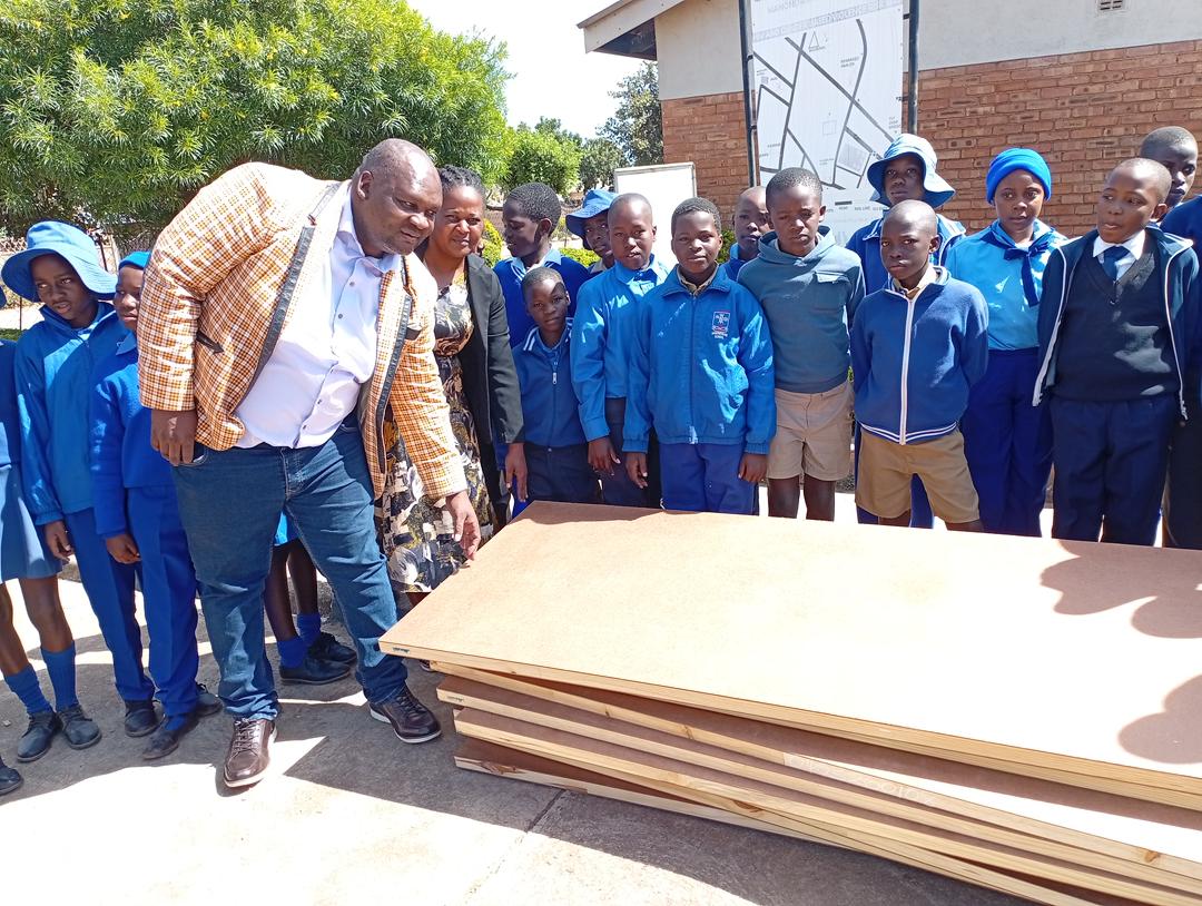 Ward 24 Councillor Tavengwa Zidya hands over doors to Manondwane Primary School in Nketa