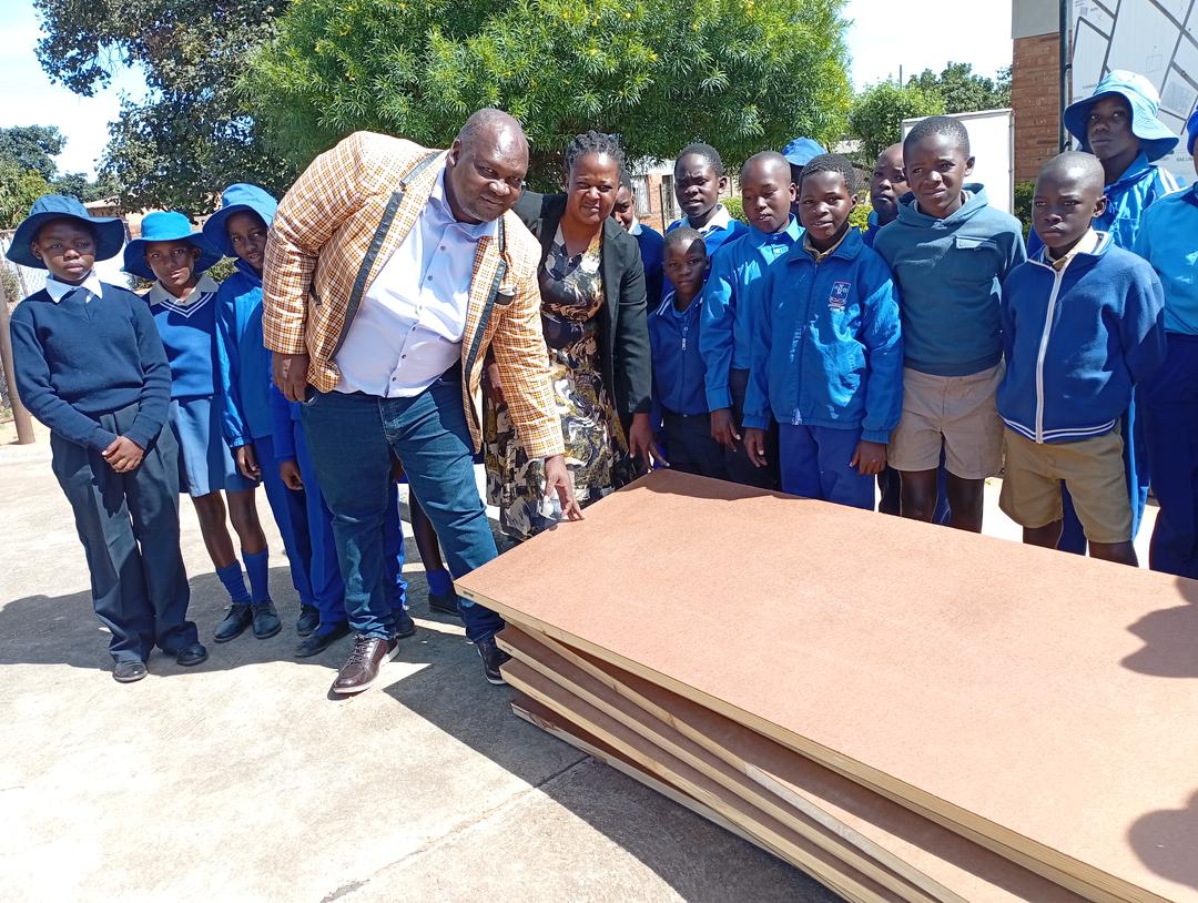 Ward 24 Councillor Tavengwa Zidya hands over doors to Manondwane Primary School in Nketa