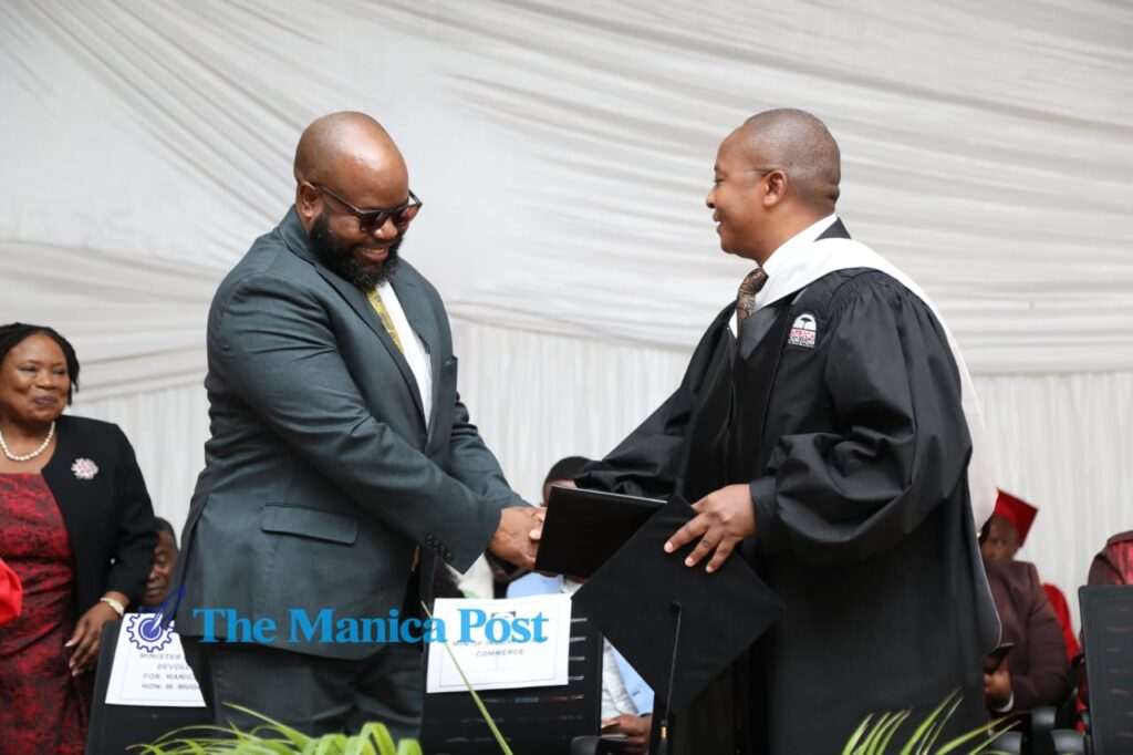 Minister Kambamura is congratulated by Minister Mugadza