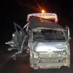 The wreckage of the kombi being towed away