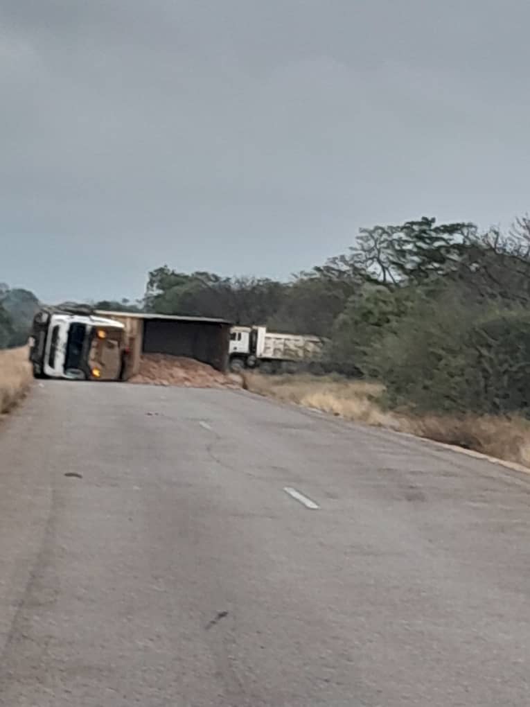 GRAVEL GIANT GOES BELLY-UP! Truck shuts down road in accident