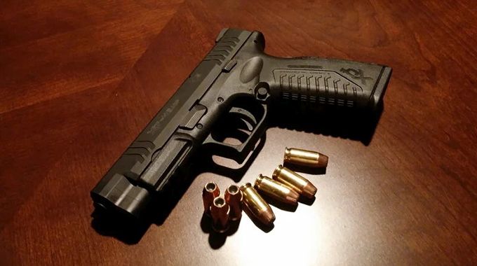 BEDROOM ARSENAL! . .Cowdray man busted after detectives find rifle and bullets under his bed