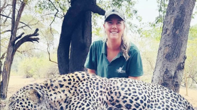 Professional hunter, Ms Tanya Blake poses beside a leopard harvested during a recent safari