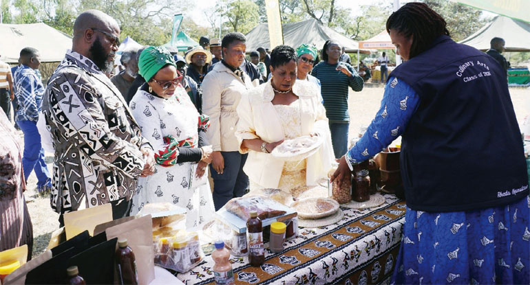 The First Lady, Amai Dr Auxillia Mnangagwa (third from left) leads the touring of exhibition stands at the Agric4She Conference in Buhera accompanied by Women Affairs, Community, Small and Medium Enterprises Development Minister, Senator Monica Mutsvangwa (centre) and Minister of State for Provincial Affairs and Devolution Manicaland Province, Advocate Misheck Mugadza
