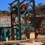 Golden Cube Corporation employees installing part of the brick moulding plant