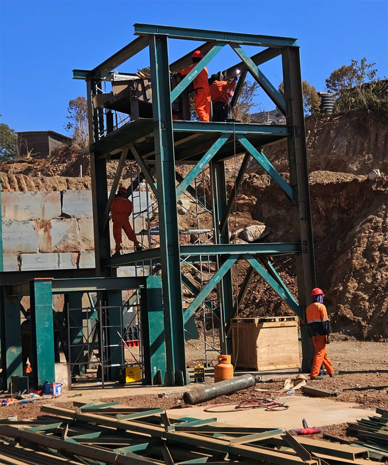 Golden Cube Corporation employees installing part of the brick moulding plant