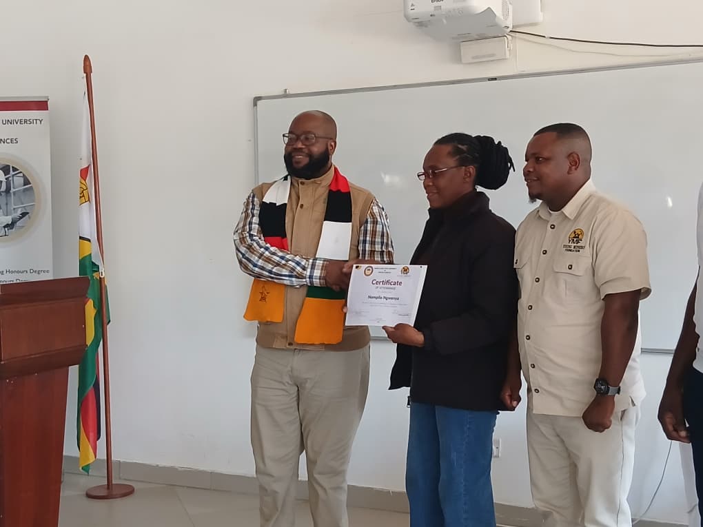 Ms Nompilo Ngwenya receives her certificate from Minister of State for Manicaland Provincial Affairs and Devolution, Advocate Misheck Mugadza and Young Miners Foundation CEO, Mr Payne Kupfuwa after completing the training