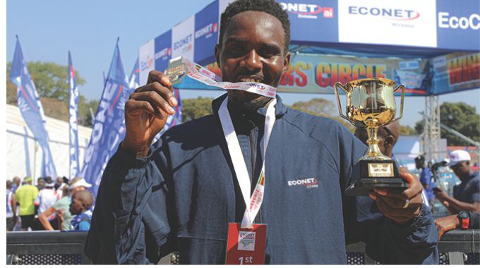 Men’s full 2026 marathon winner Tendai Zimuto holds up his medal and winner’s trophy after a brilliant performance at the 2026 Econet Victoria Falls Marathon, winning the 42-km race in a time of 2:16:10.