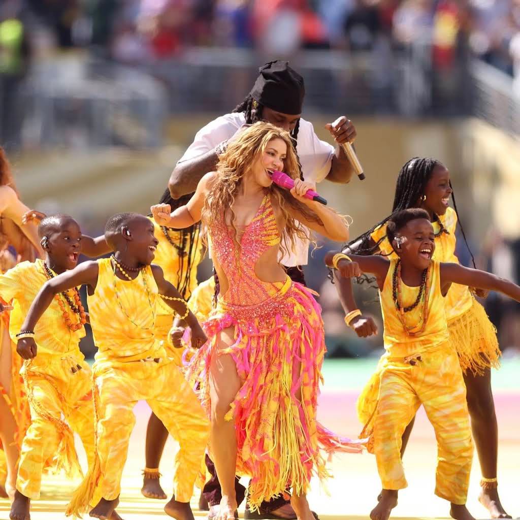 The group onstage performing with both Shakira and Burna Boy at the FIFA World Cup Final