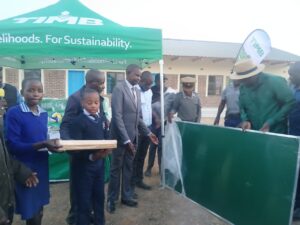 Minister of State for Provincial Affairs and Devolution, Cde Christopher Magomo (wearing a hat), and Tobacco Industry and Marketing Board (TIMB) chief executive Mr Emmanuel Matsvaire (centre)
