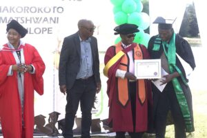 From left, Dr. Audrey Rufaro Sitembile Mabveni (in the red gown), Zimbabwe Sugar Association board chair Kudakwashe Chipatiso, and Agriculture, Mechanisation and Water Resources Development Permanent Secretary Professor Obert Jiri handing over a certificate to one of the graduates.