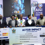 ICT, Postal and Courier Services Minister, Hon. Tatenda Mavetera (third from right), presents a cheque worth US$21 000 and a trophy to Midlands State University Computer Systems Engineering student Nigel Ephraim Basarokwe (center) after he won first place in the Data Track category during the AI for Impact Challenge, organised by POTRAZ, in Nyanga, Manicaland Province, last Friday. Looking on are Permanent Secretary Dr Beaullar Chirume (right), Minister of State for Manicaland Provincial Affairs and Devolution Advocate Misheck Mugadza (second from right), and POTRAZ Director-General Dr Gift Machengete (third from left). – Picture: Nyasha Chawatama