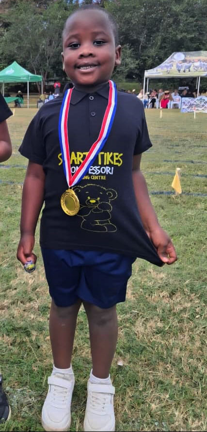Aidan Mbofana after winning a medal for athletics at creche