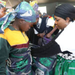 Culture and Heritage Ambassador First Lady, Dr Auxillia Mnangagwa teaches a young girl how to wrap a zambia during a Nhanga session at the Boys and Girls Mentorship Camp in Nyanga, promoting cultural heritage and preservation of traditional customs among the younger generation. - Pictures: Justin Mutenda